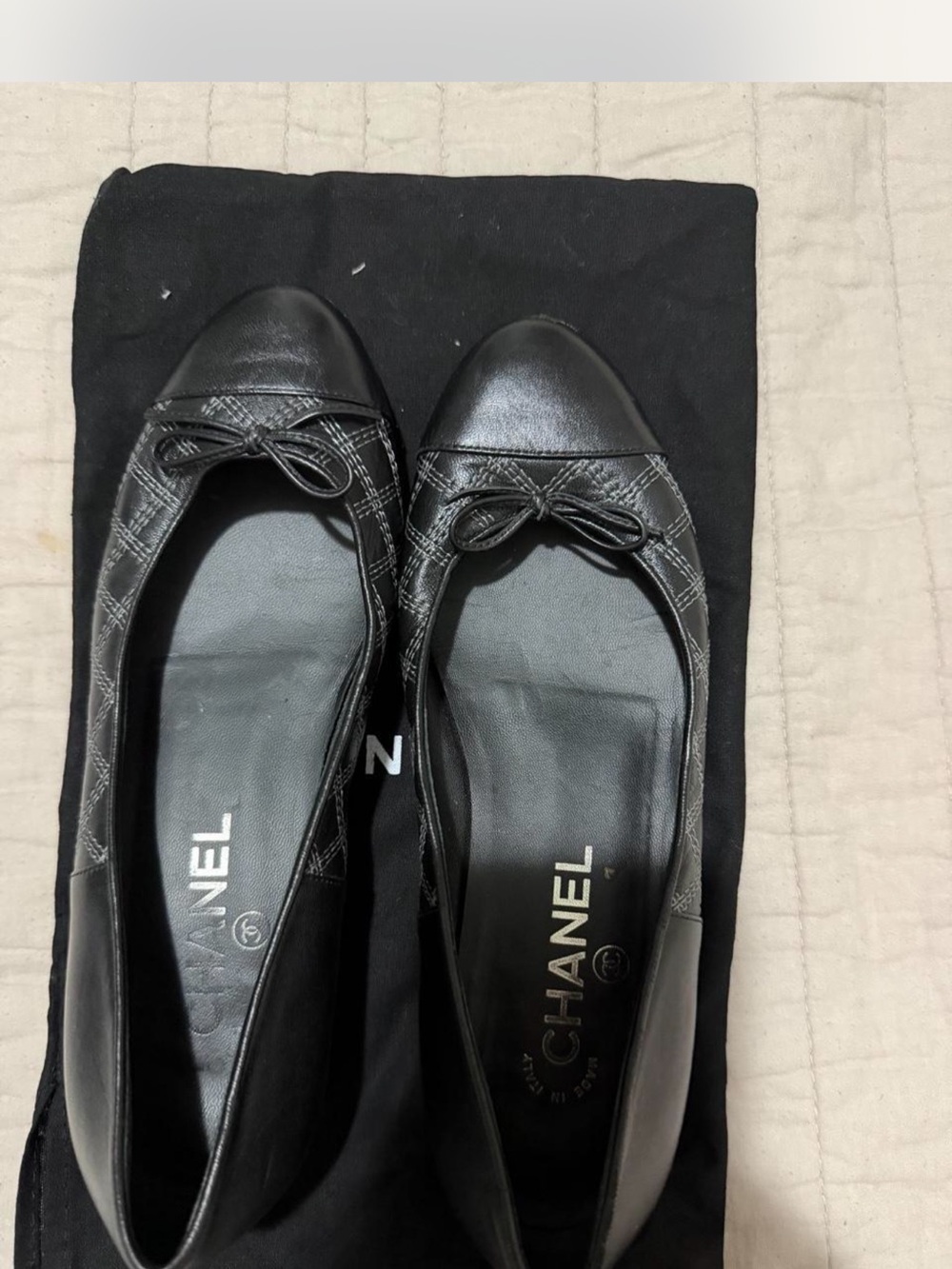 CHANEL Black Quilted Leather Cap-Toe Ballet Flats with Bow